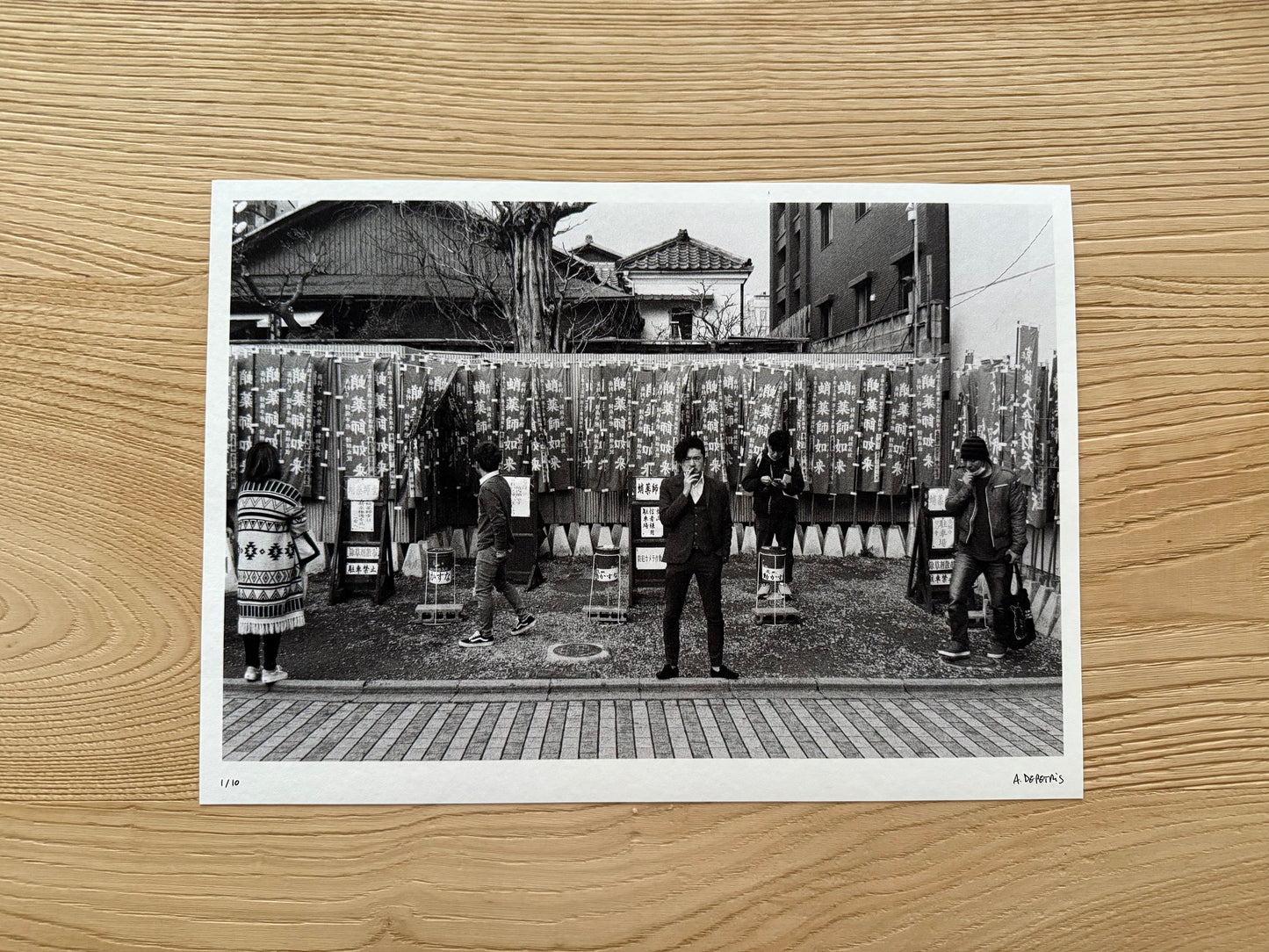 Black and white photo of people in a traditional setting on a wooden surface