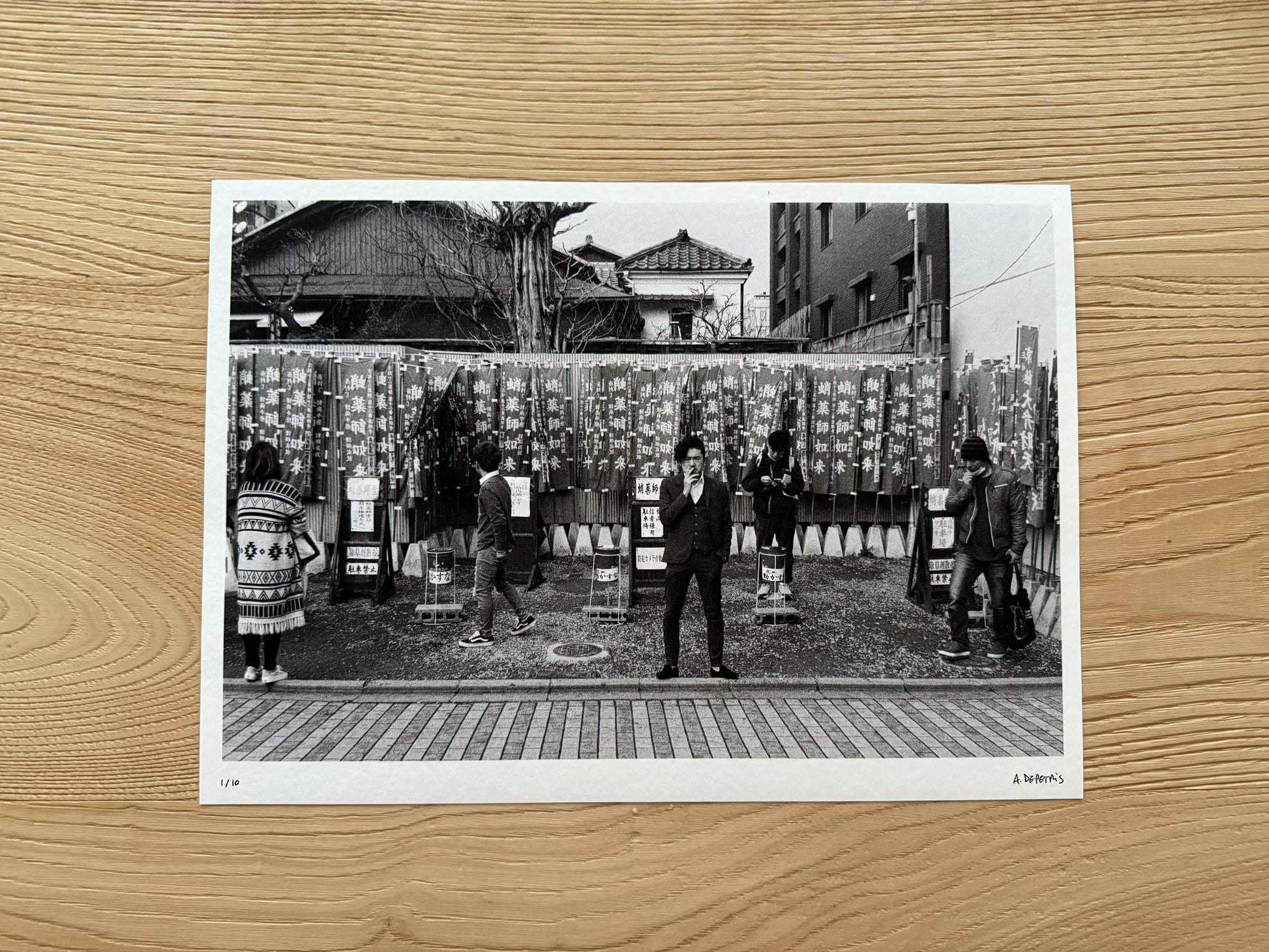 Black and white photo of people in a traditional setting on a wooden surface